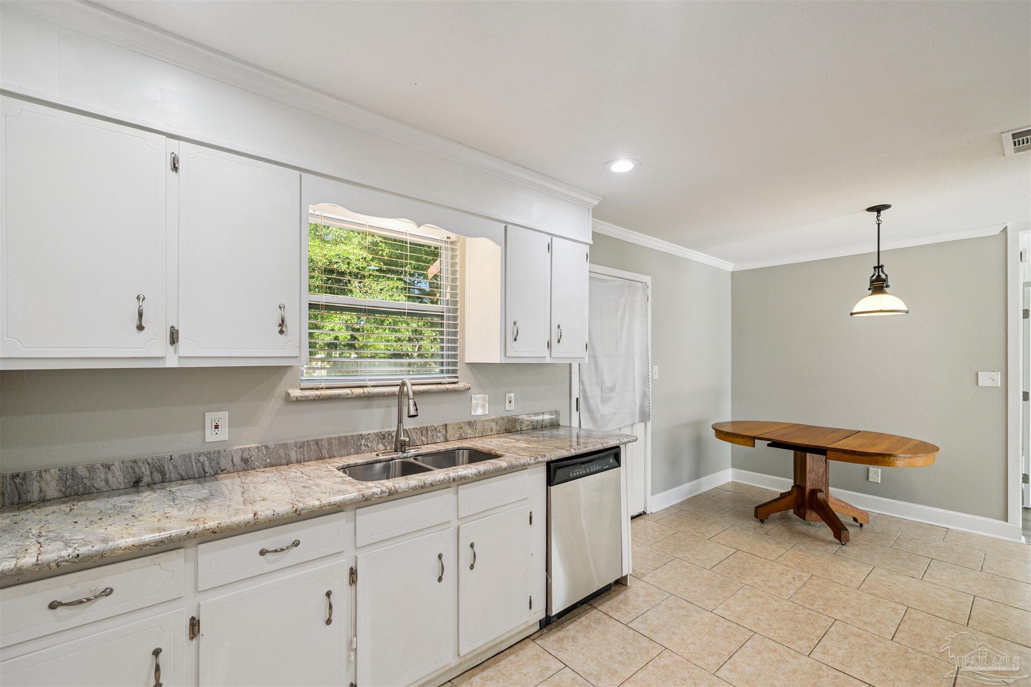 4250 Avenida San Marcus Pace, FL 32571 - Photo 14 of 23 a kitchen with sink cabinets and window