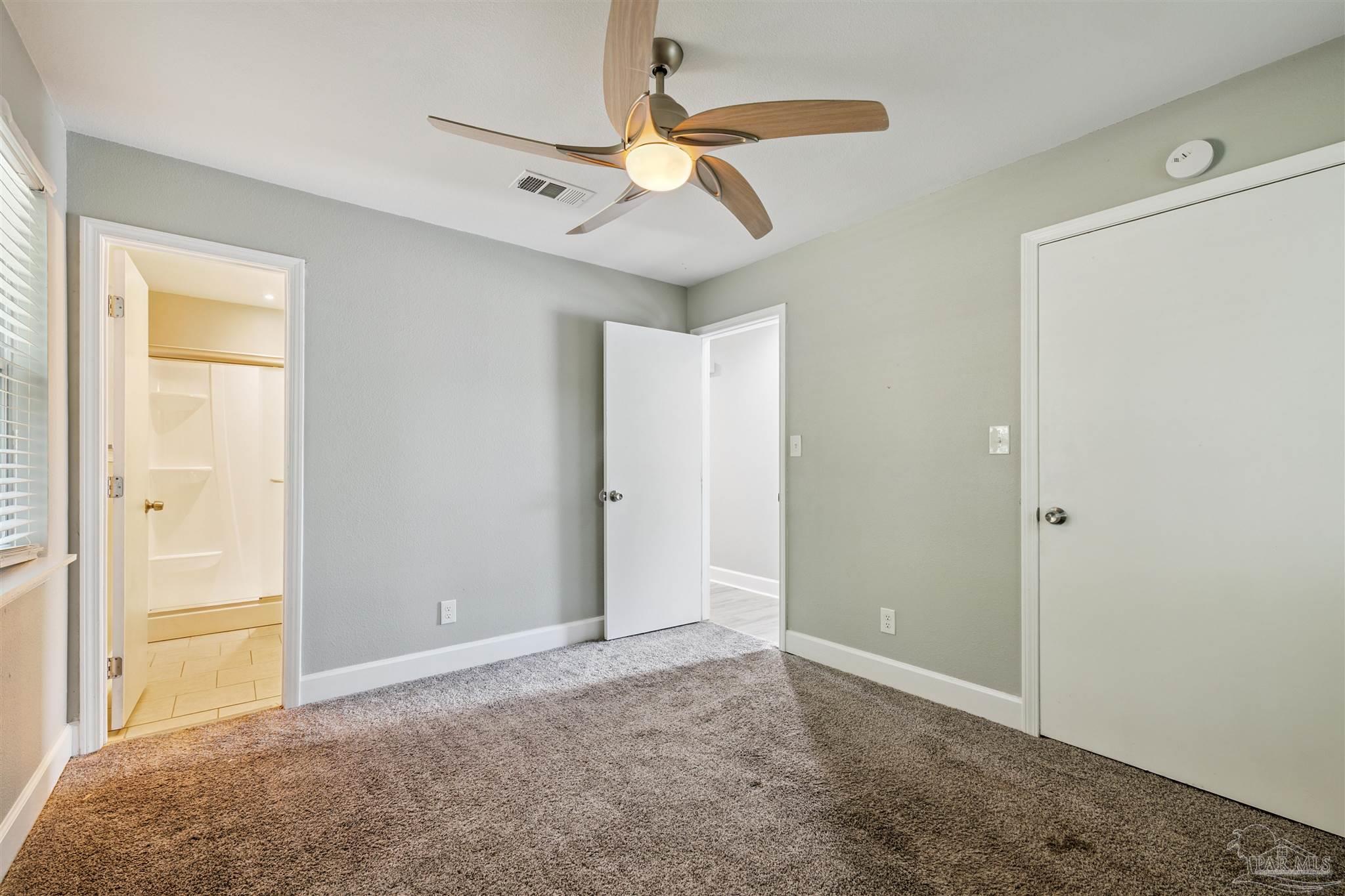 4250 Avenida San Marcus Pace, FL 32571 - Photo 19 of 23 an empty room with closet and a chandelier fan