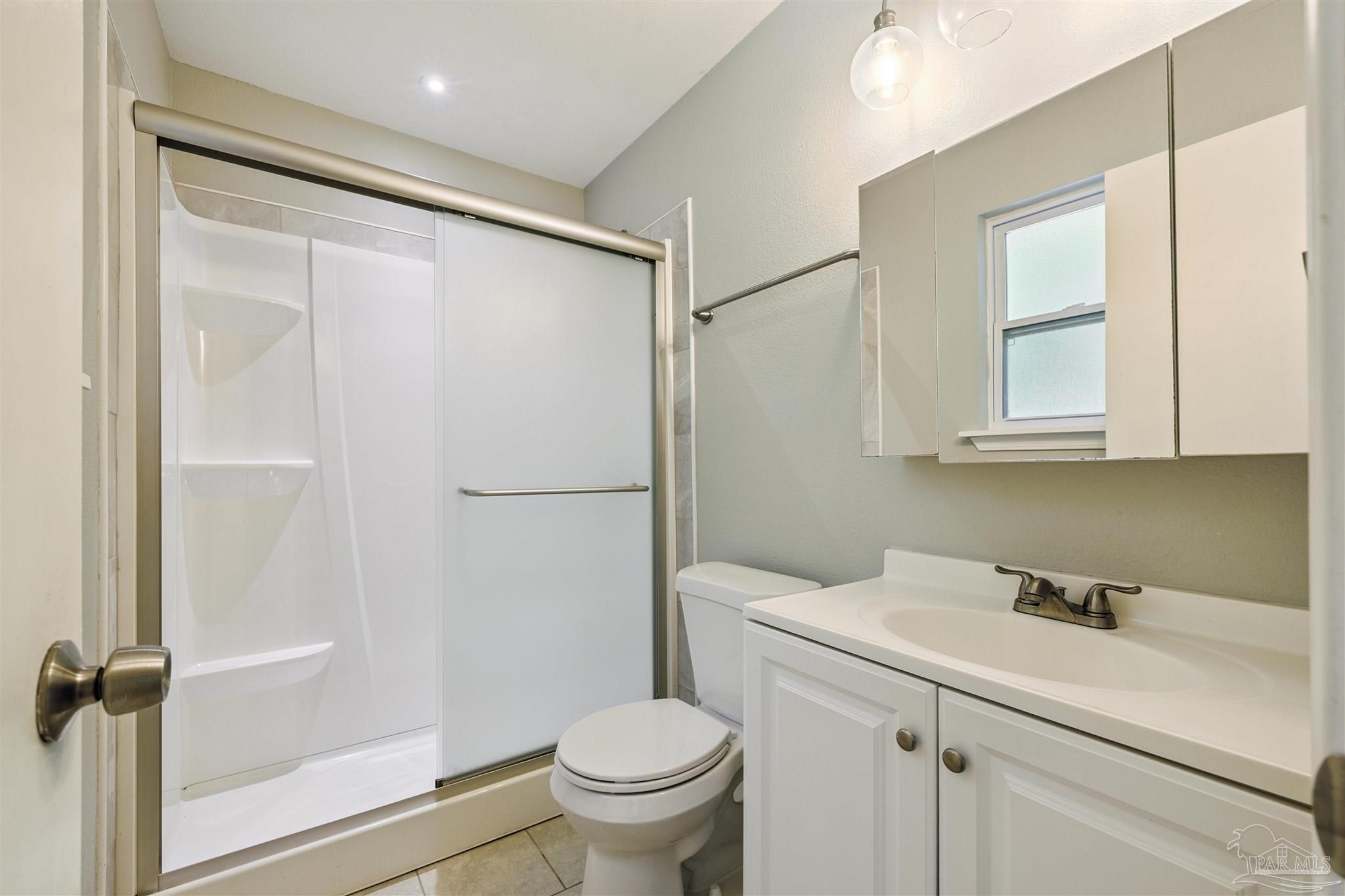 4250 Avenida San Marcus Pace, FL 32571 - Photo 20 of 23 a bathroom with a sink toilet and vanity