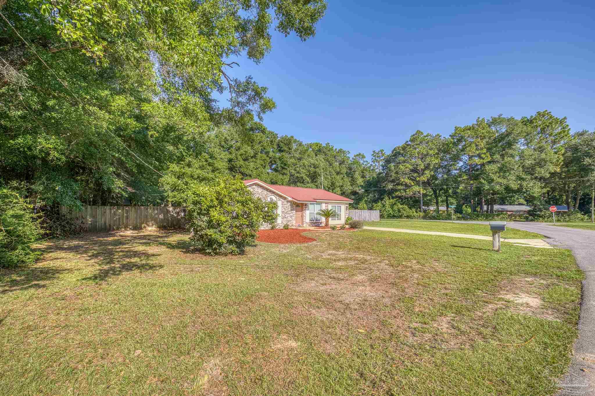 4250 Avenida San Marcus Pace, FL 32571 - Photo 2 of 23 a view of a yard with a tree