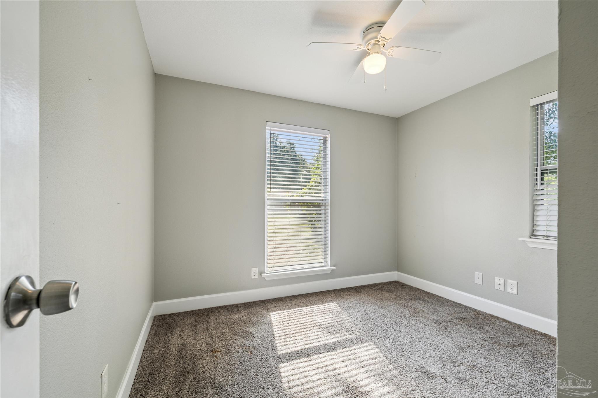 4250 Avenida San Marcus Pace, FL 32571 - Photo 21 of 23 an empty room with windows and fan