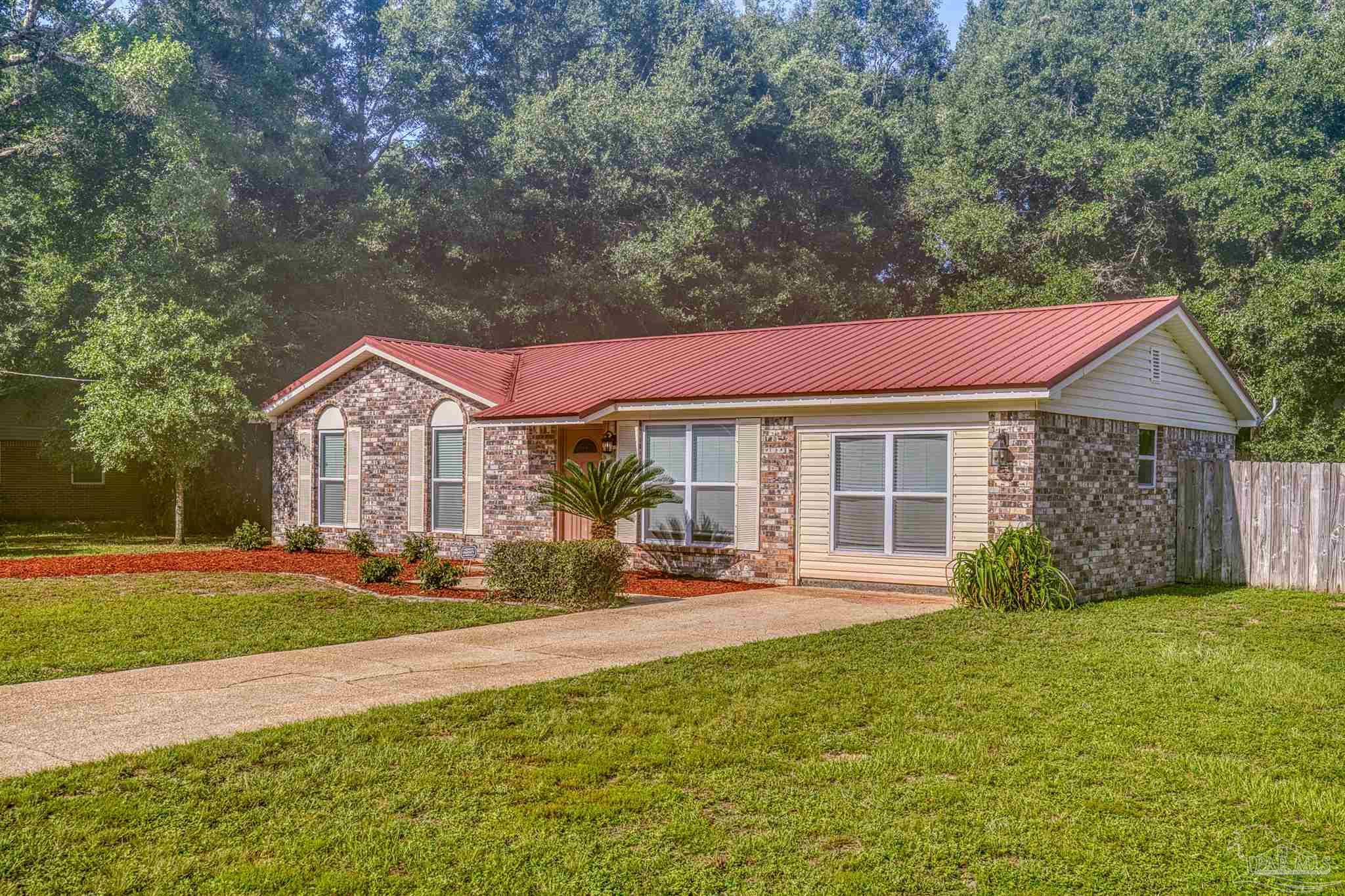 4250 Avenida San Marcus Pace, FL 32571 - Photo 3 of 23 a view of a house with a yard patio and fire pit