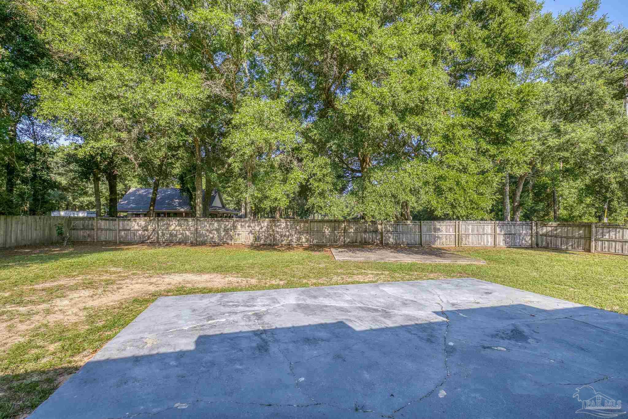 4250 Avenida San Marcus Pace, FL 32571 - Photo 4 of 23 a view of swimming pool with a yard and large trees