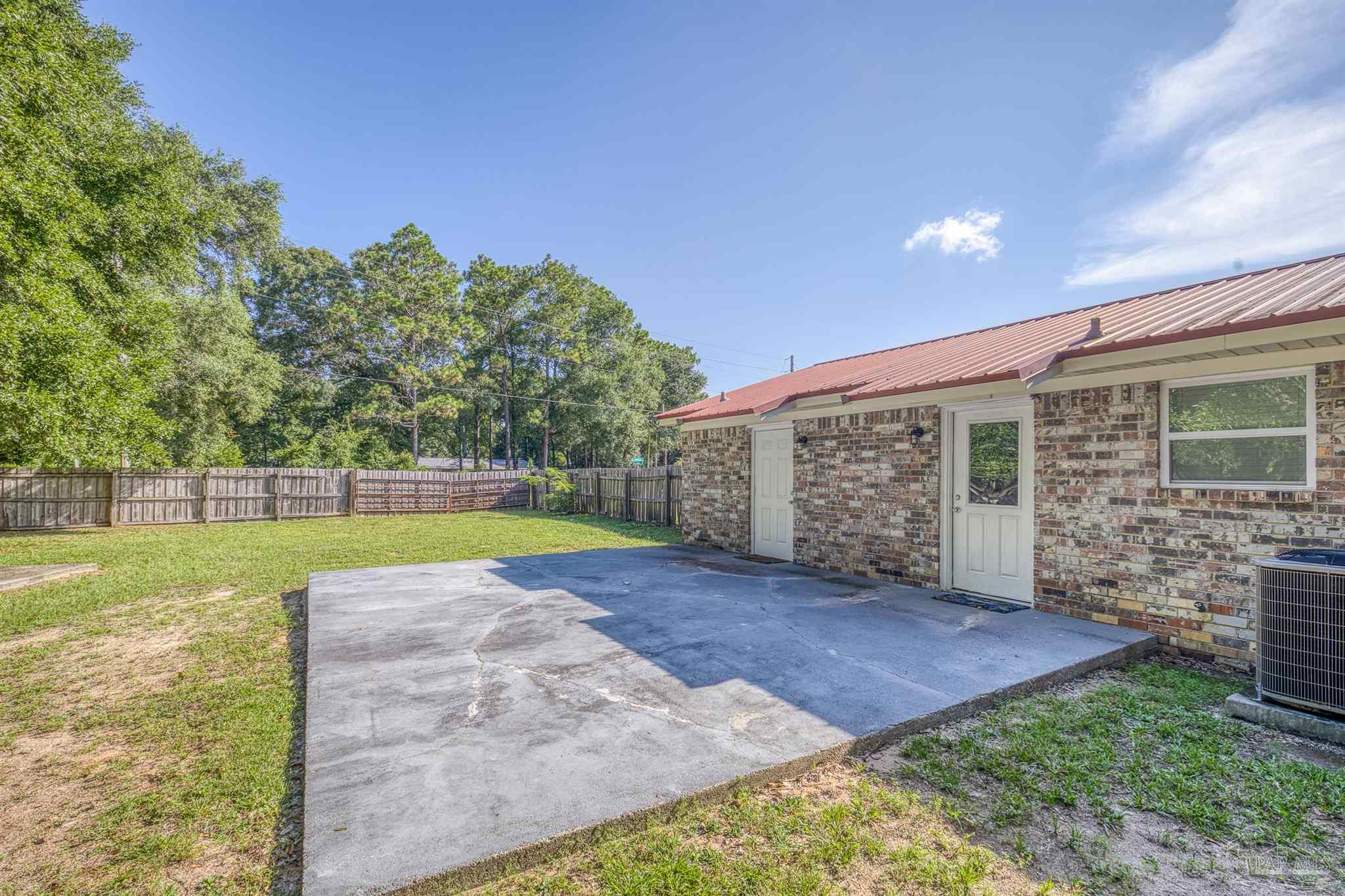 4250 Avenida San Marcus Pace, FL 32571 - Photo 6 of 23 a view of a house with a yard