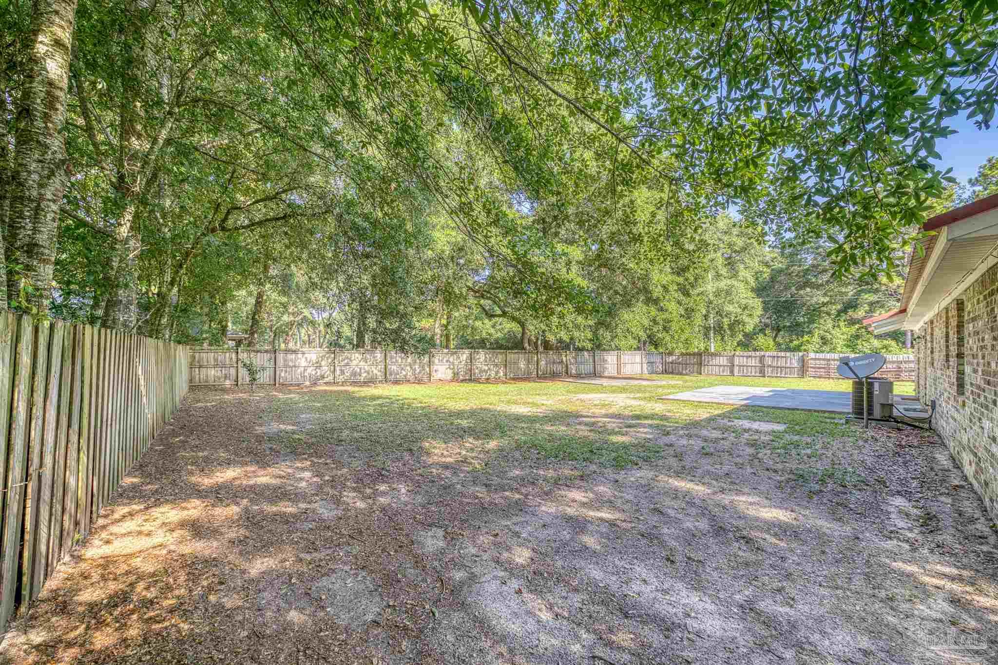 4250 Avenida San Marcus Pace, FL 32571 - Photo 7 of 23 a view of a yard with large trees