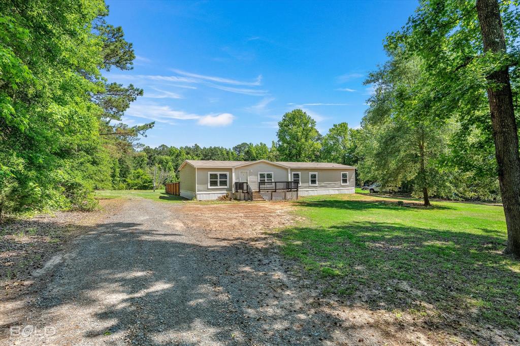2153 Highway 2 Plain Dealing, LA 71064 - Photo 5 of 39 a front view of a house with a garden