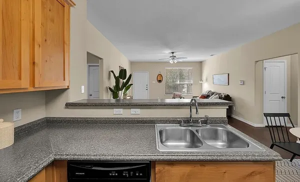 a kitchen with sink and cabinets