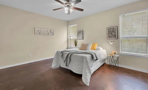 a bedroom with a bed and a window