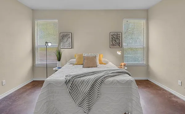 a bedroom with a bed and window