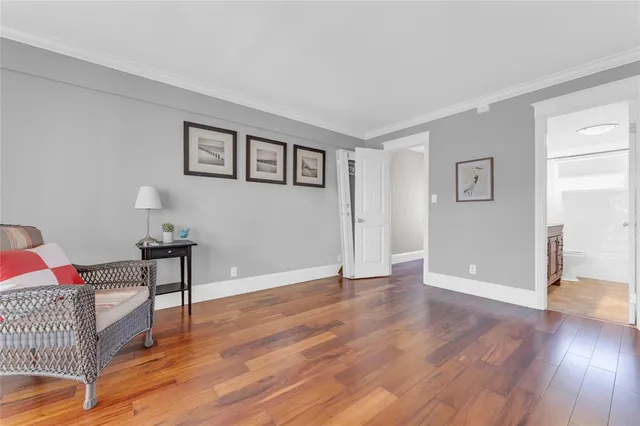 a view of a livingroom with wooden floor and a cabinet