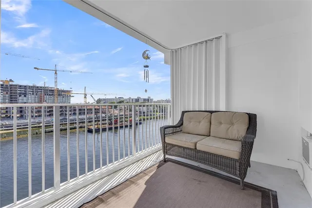 a balcony with furniture and city view