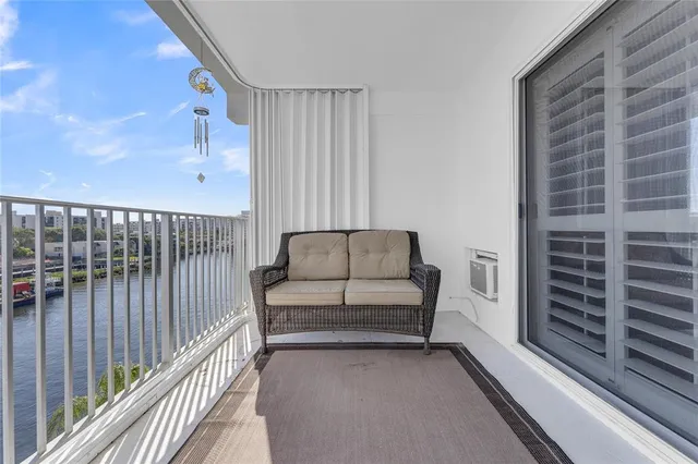 a view of a balcony with wooden floor and fence