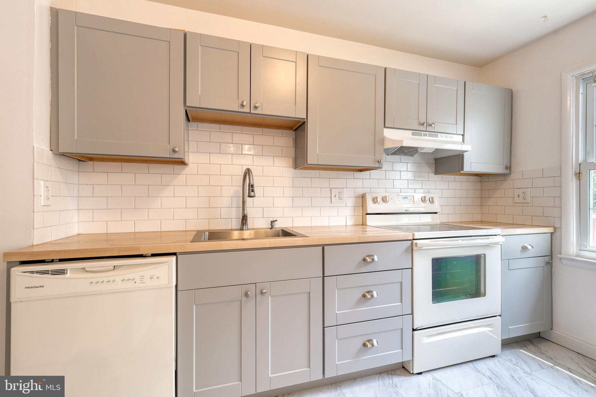 3429 Saluda Road Nottingham, MD 21236 - Photo 12 of 37 a kitchen with white cabinets white stainless steel appliances and sink