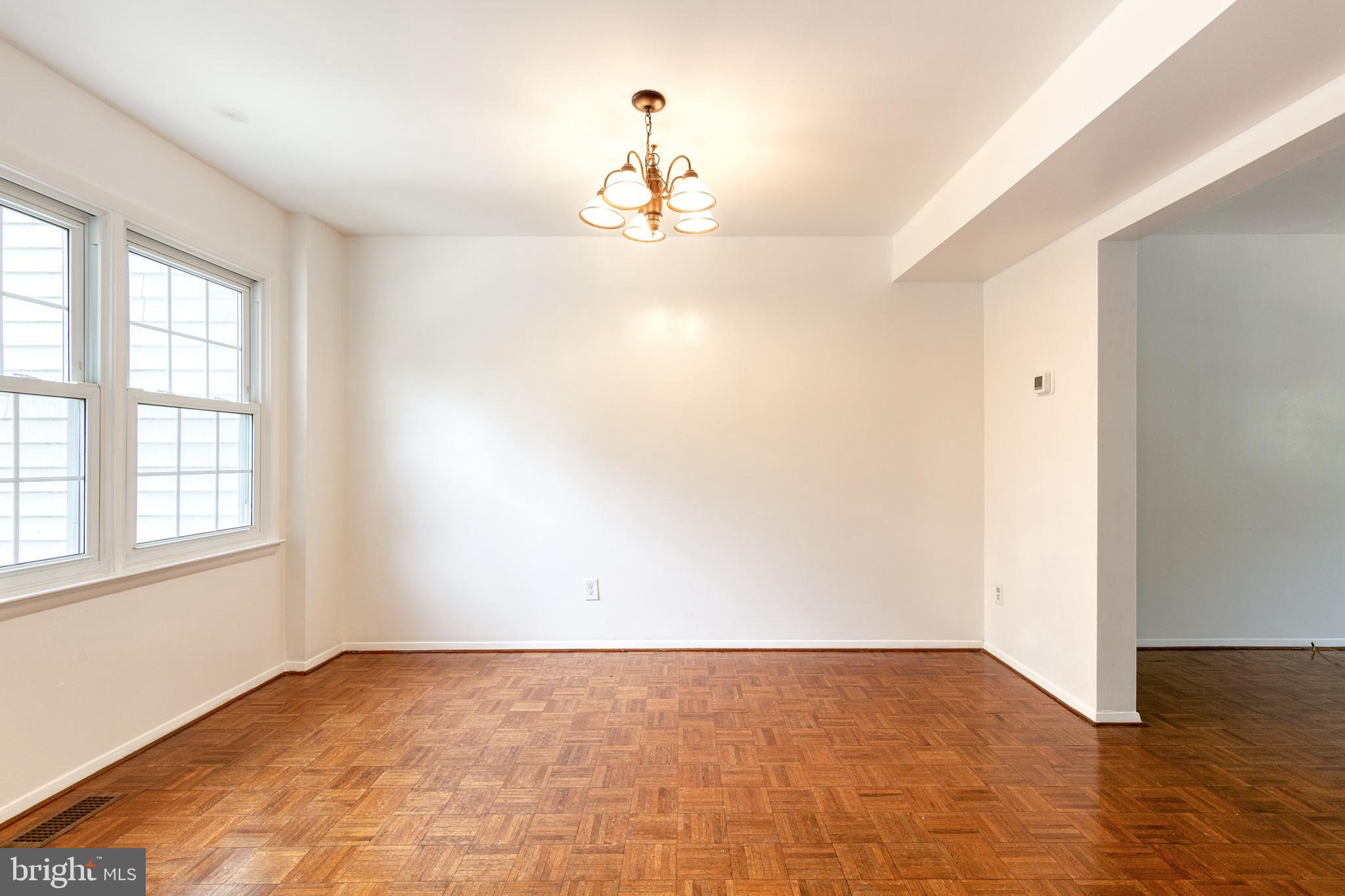 3429 Saluda Road Nottingham, MD 21236 - Photo 16 of 37 an empty room with wooden floor and windows