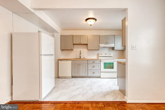 a kitchen with a sink cabinets and window