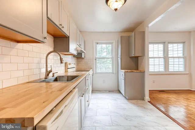 a view of a kitchen with wooden floor and electronic appliances