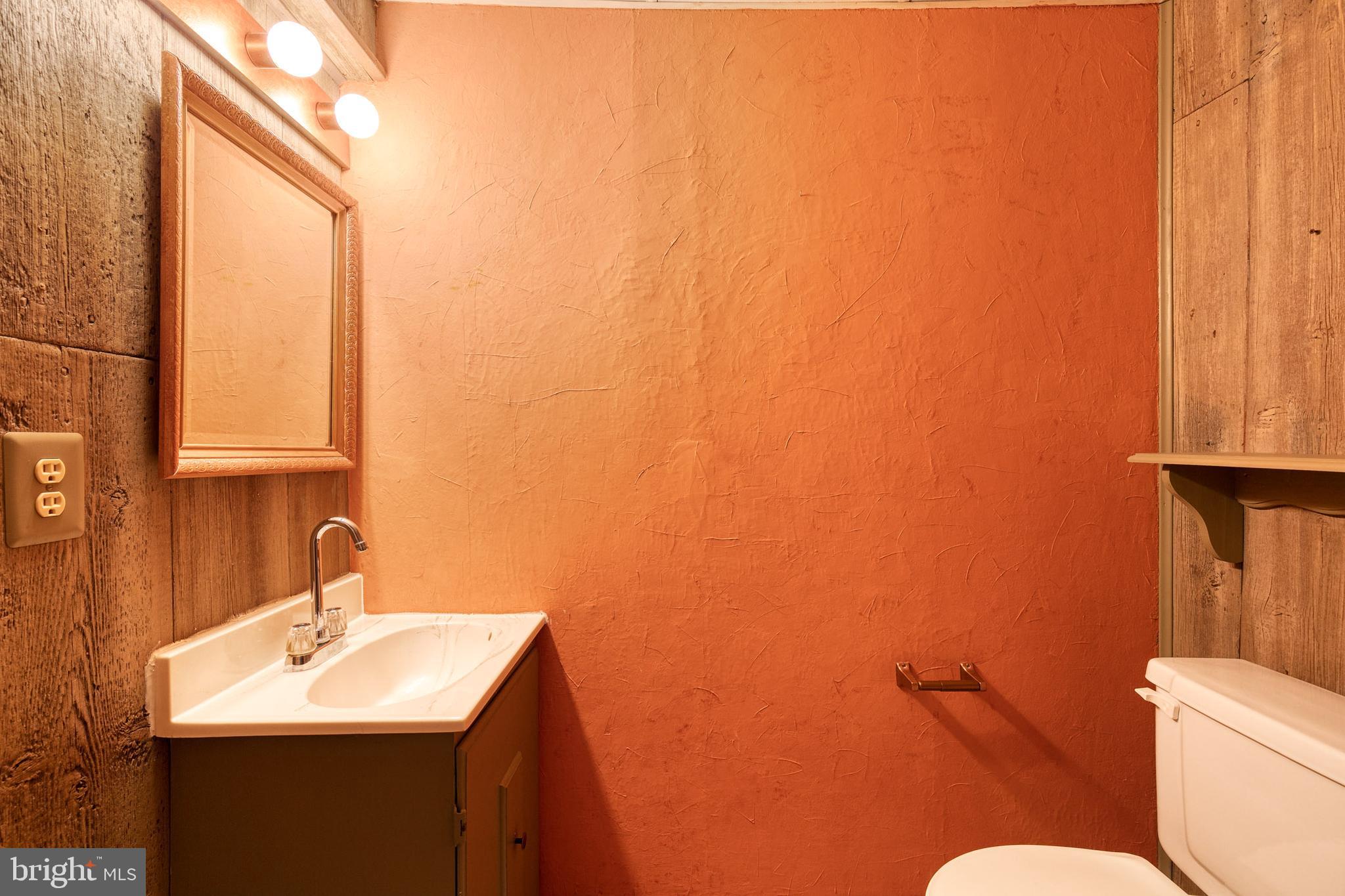 3429 Saluda Road Nottingham, MD 21236 - Photo 32 of 37 a bathroom with a sink mirror and toilet