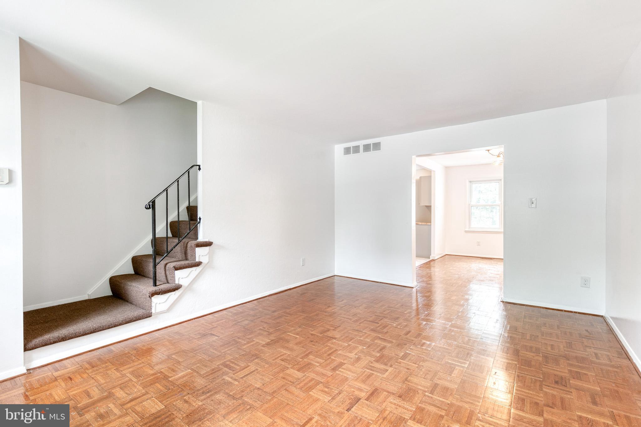 3429 Saluda Road Nottingham, MD 21236 - Photo 7 of 37 a view of an empty room with wooden floor and potted plants