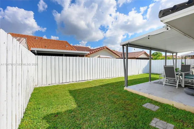 a view of a backyard with a sitting area