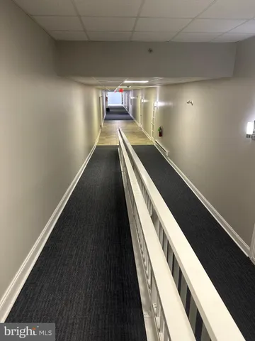 an empty room with wooden floor and a window