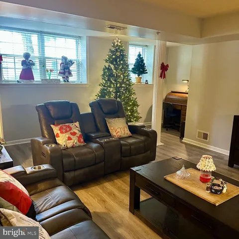 a living room with furniture and a lamp