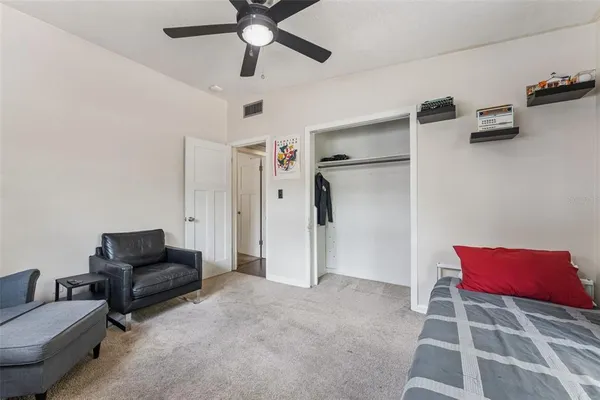 a living room with furniture and a ceiling fan