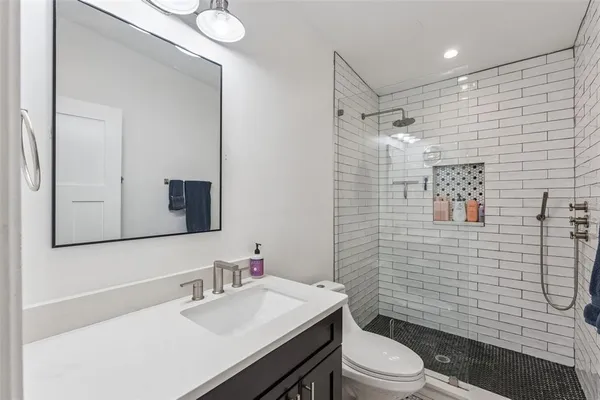 a bathroom with a sink toilet and shower