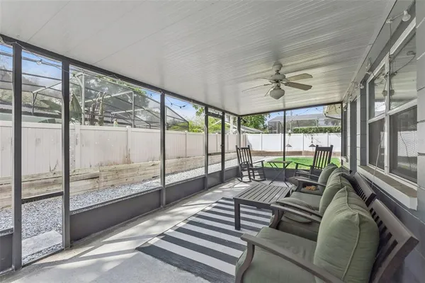 a living room with furniture and a floor to ceiling window