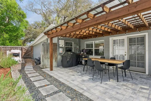 a view of a patio with table and chairs and potted plants