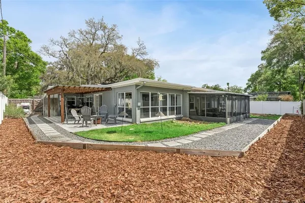 a front view of a house with a yard table and chairs