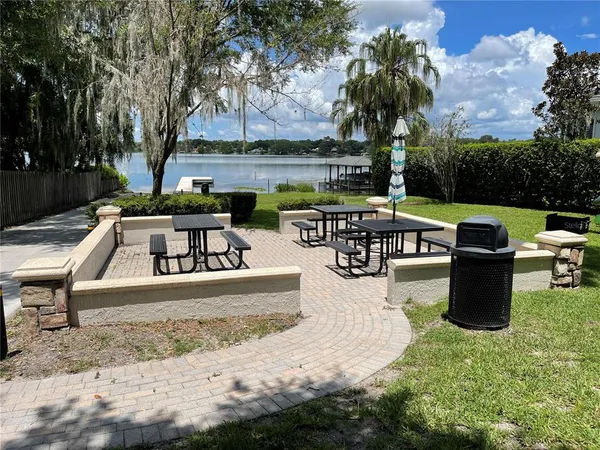 a view of a patio with couches and a fire pit