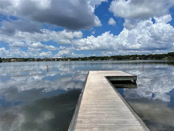 a view of a yard with wooden fence