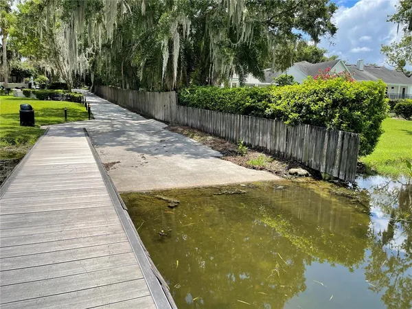 a front view of a house with a garden and trees