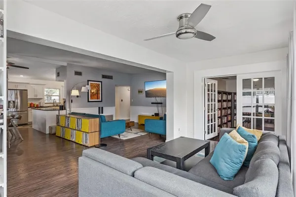 a living room with furniture and wooden floors