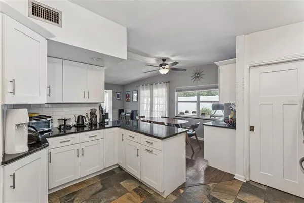 a kitchen with cabinets a sink and appliances