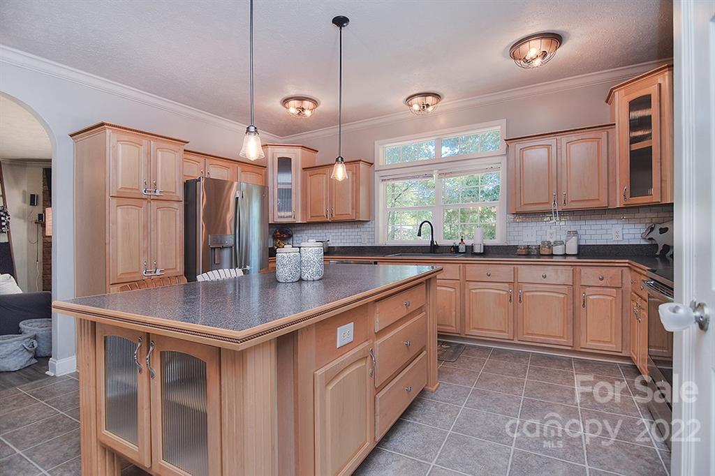 130 Printhad Road Dallas, NC 28034 - Photo 11 of 43 a kitchen with stainless steel appliances granite countertop a sink a stove a refrigerator a center island and cabinets