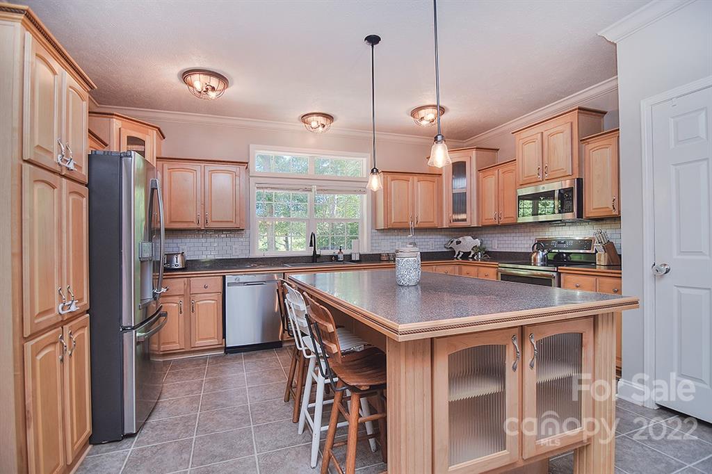 130 Printhad Road Dallas, NC 28034 - Photo 12 of 43 a kitchen with kitchen island granite countertop a sink a center island and appliances