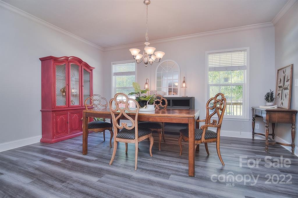 130 Printhad Road Dallas, NC 28034 - Photo 18 of 43 a dining room with furniture a chandelier and wooden floor