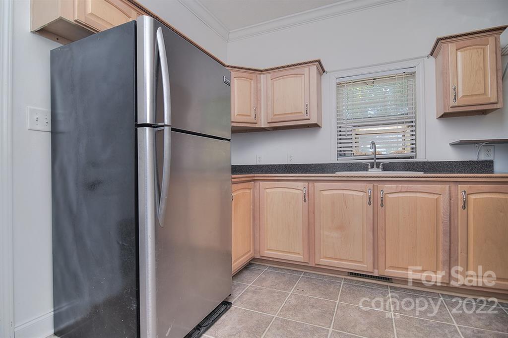 130 Printhad Road Dallas, NC 28034 - Photo 23 of 43 a kitchen with white cabinets and refrigerator