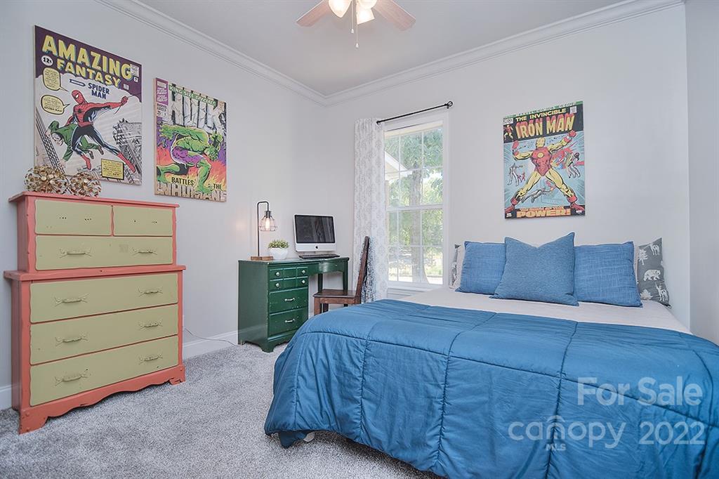 130 Printhad Road Dallas, NC 28034 - Photo 27 of 43 a bedroom with a bed and a bookshelf