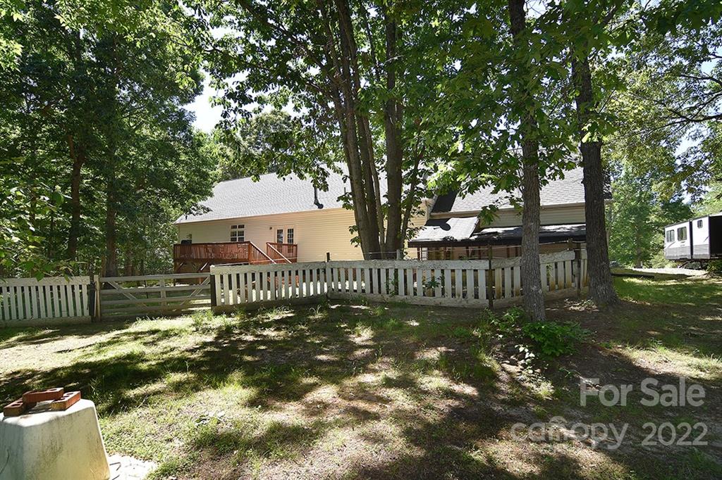 130 Printhad Road Dallas, NC 28034 - Photo 35 of 43 a view of a small yard in front of a house with a large tree