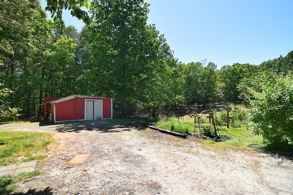 130 Printhad Road Dallas, NC 28034 - Photo 42 of 43 a view of backyard with large trees and plants