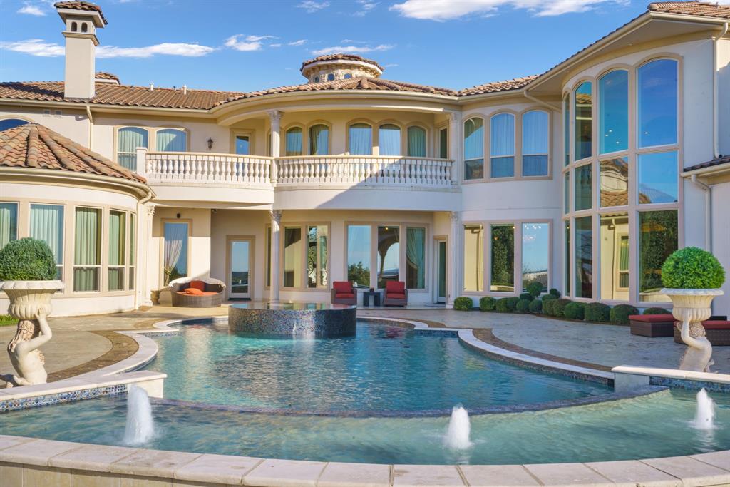 6509 Sudbury Road Plano, TX 75024 - Photo 18 of 23 Rear view of property featuring a pool with connected hot tub, a balcony, and stucco siding