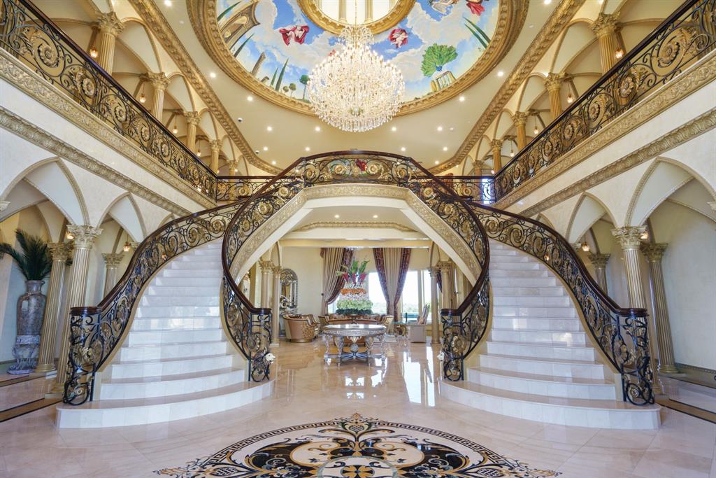 6509 Sudbury Road Plano, TX 75024 - Photo 4 of 23 Foyer entrance with stairway, a high ceiling, ornate columns, and arched walkways