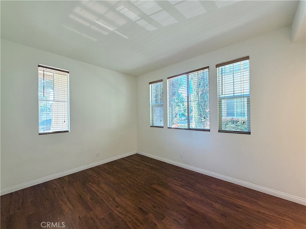 111 Liberty Street Tustin, CA 92782 - Photo 5 of 8 an empty room with wooden floor and windows