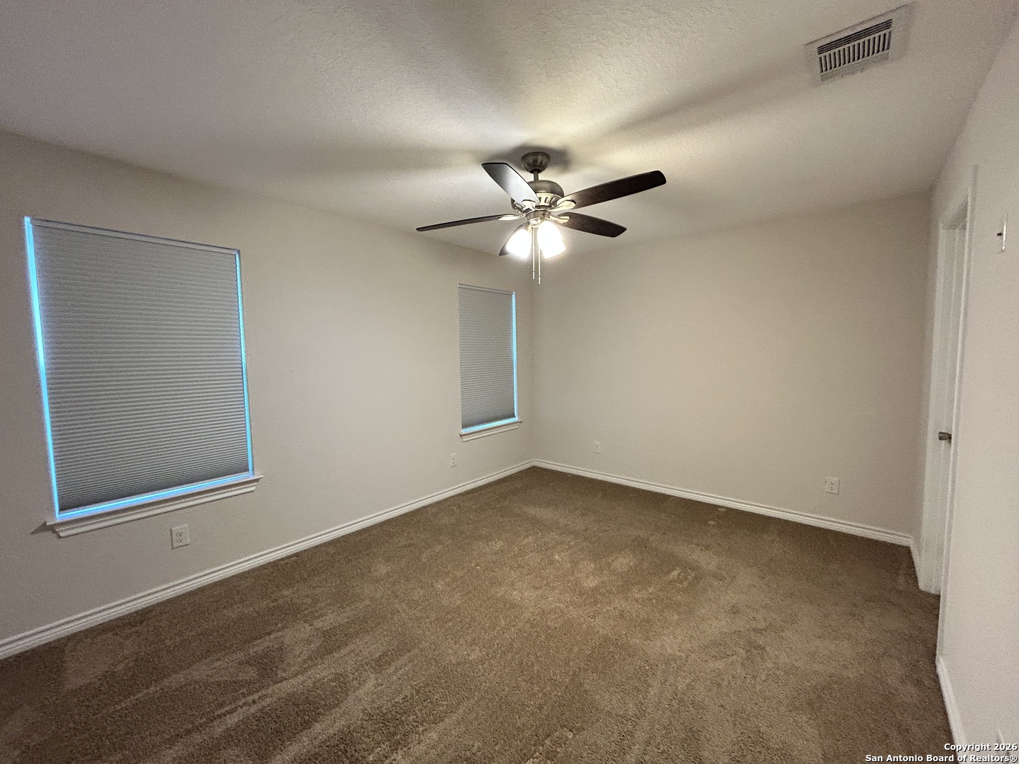 6926 Crestway Road, Unit 3 San Antonio, TX 78239 - Photo 11 of 13 an empty room with a window and a fan
