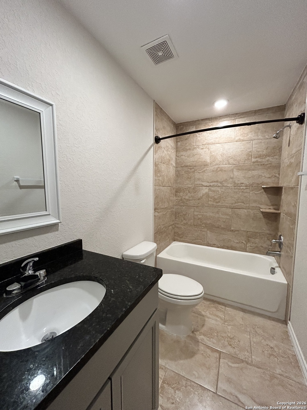 6926 Crestway Road, Unit 3 San Antonio, TX 78239 - Photo 8 of 13 a bathroom with a granite countertop sink a toilet a mirror and bathtub