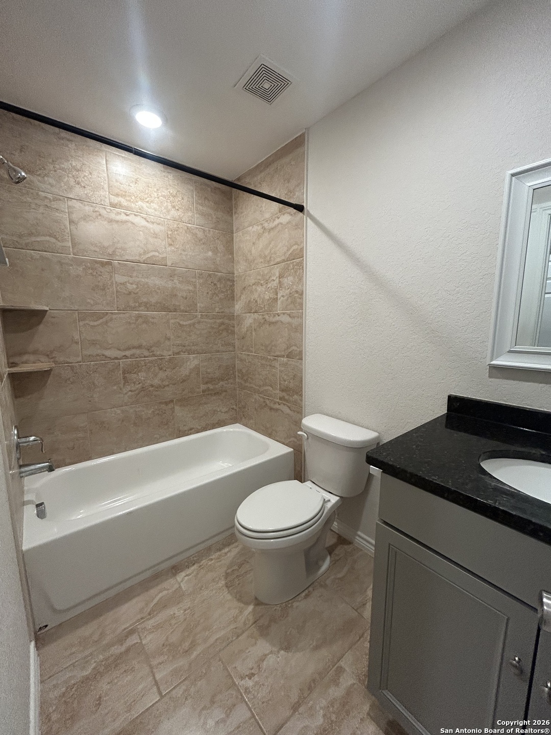 6926 Crestway Road, Unit 3 San Antonio, TX 78239 - Photo 10 of 13 a bathroom with a granite countertop sink toilet and shower