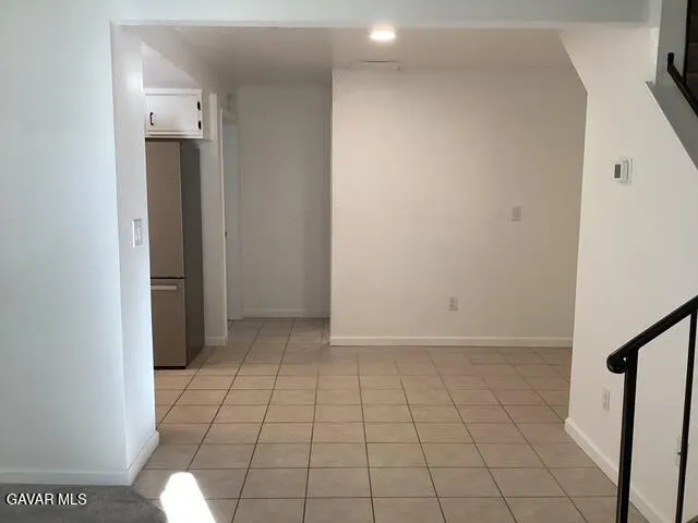 an empty room with an entryway and sink