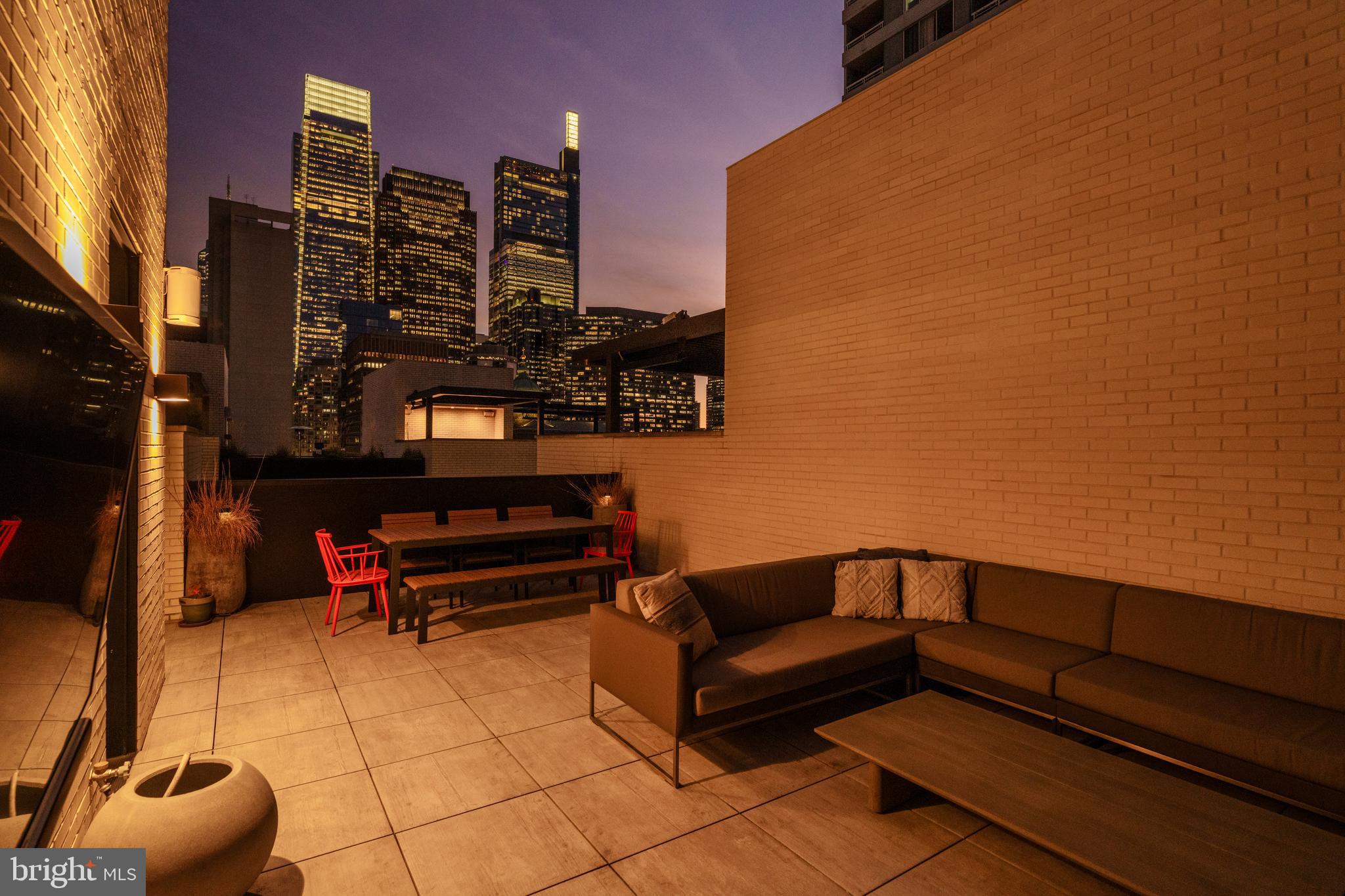1646 Carlton Street Philadelphia, PA 19103 - Photo 46 of 66 a roof deck with couch and chairs